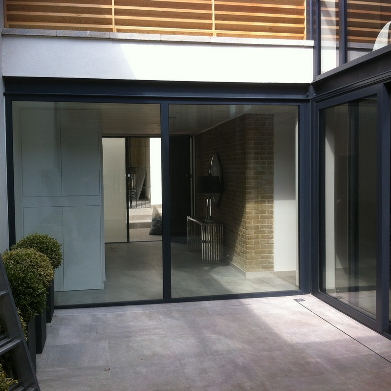 Floor-to-ceiling sliding doors opening to courtyard in Stamford Hill