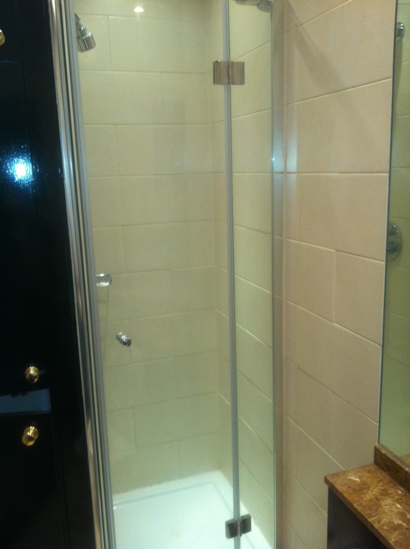 Frameless glass shower enclosure with chrome fittings in Stamford Hill
