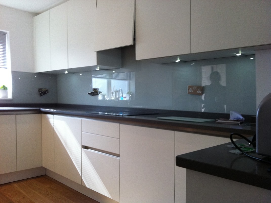 Grey glass kitchen splashback with LED lighting in Stamford Hill