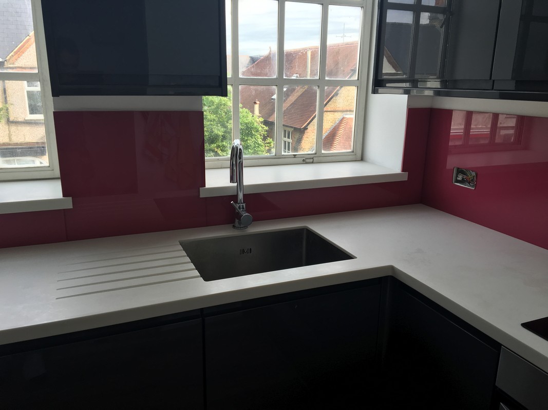Deep plum coloured glass splashback in modern Stamford Hill kitchen
